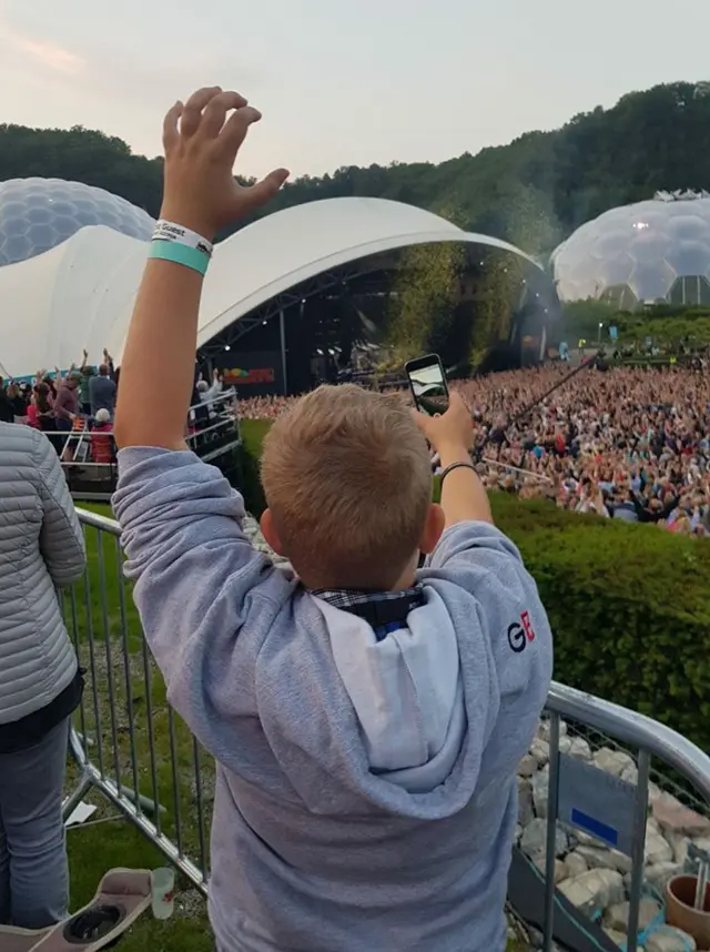 young boy watching open air concert