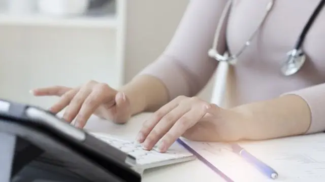 Doctor at tablet computer