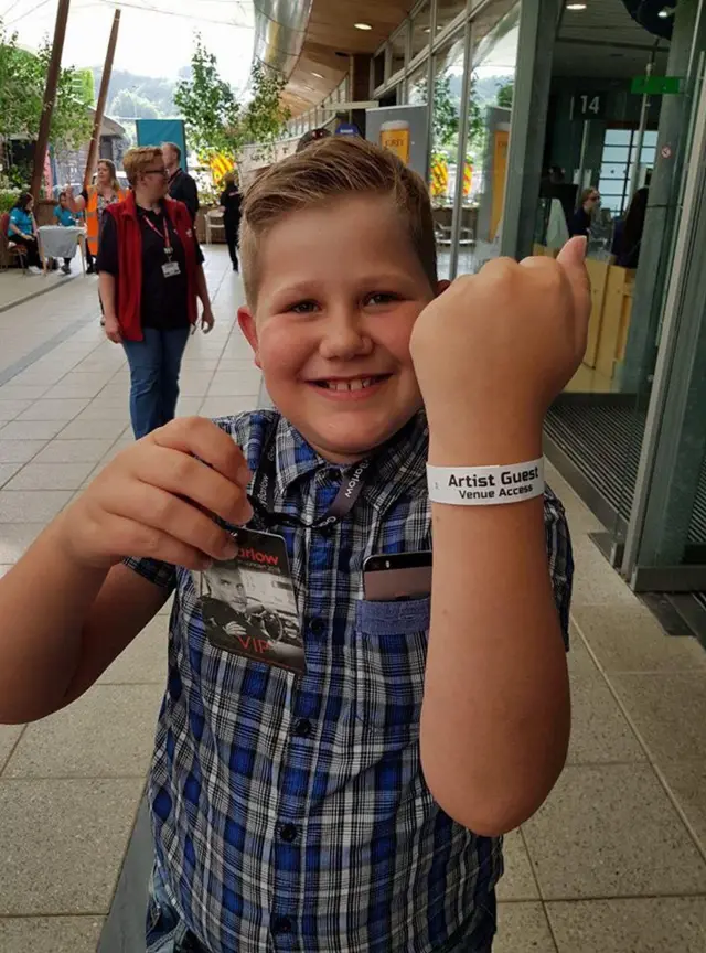 young boy with VIP pass