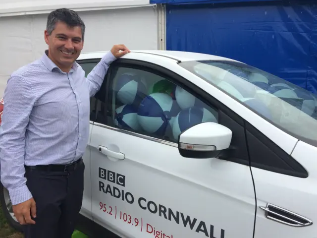 Mark Grinnell with car filled with beach balls