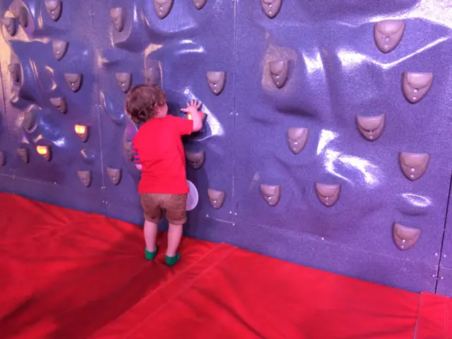 Toddler at climbing wall