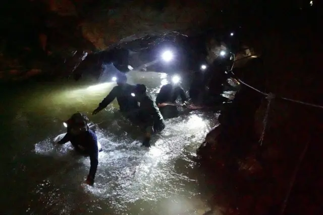 Navy Seals wade through Tham Luang cave