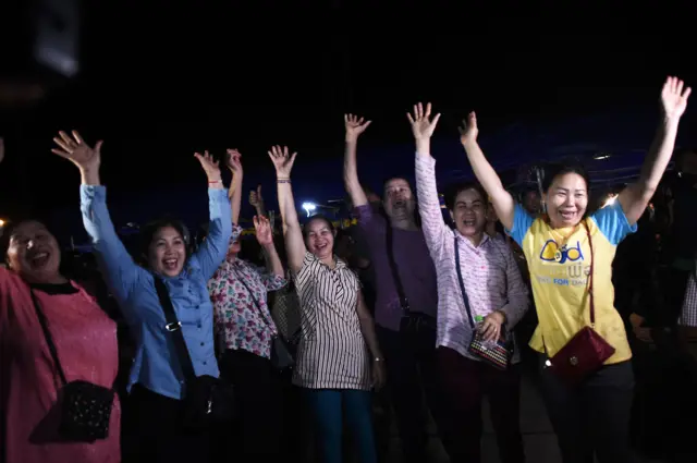 Volunteers celebrate at a makeshift press centre in Mae Sai district of Chiang Rai province on July 10, 2018