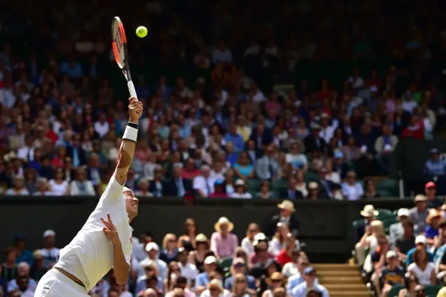 Kei Nishikori serves