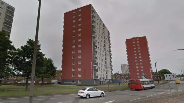 Firbeck House, a tower block, beside a road