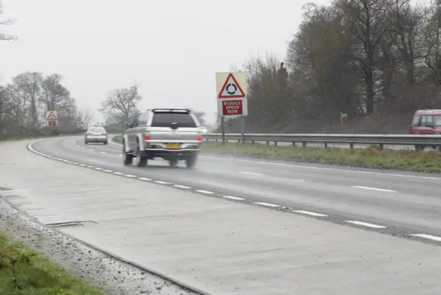 A car drives on a wet road