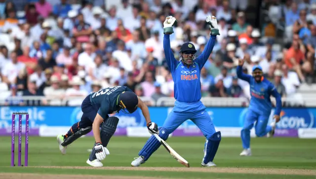 Jos Buttler of England is caught behind by MS Dhoni