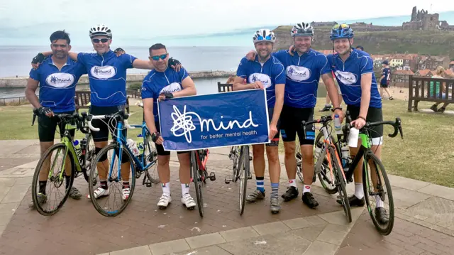 Six cyclists with mind banner