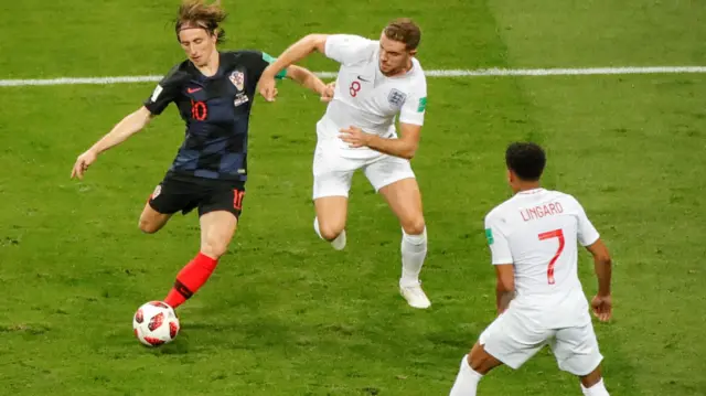 Croatia's Luka Modric takes the ball away from England's Jordan Henderson