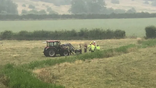 Tractors at the site where the cow's stuck