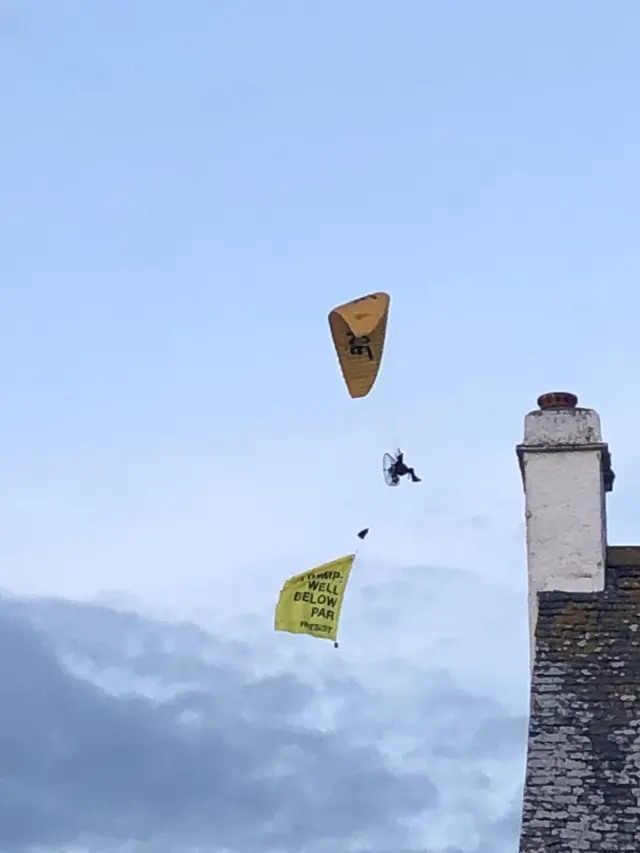 Flying protester with banner