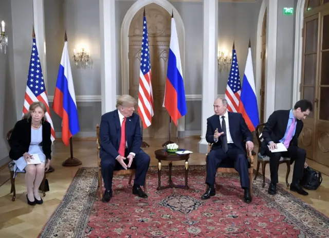 Presidents Donald Trump and Vladimir Putin sit side by side