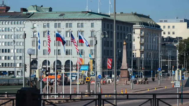 American and Russian flags are pictured at the market square near the Finnish presidential palace in Helsinki, Finland