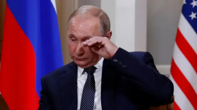 President Putin rubs something from the corner of his eye as the talks begin