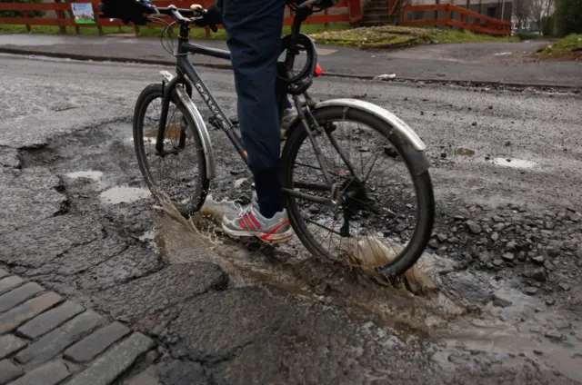 Bike going through a pothole