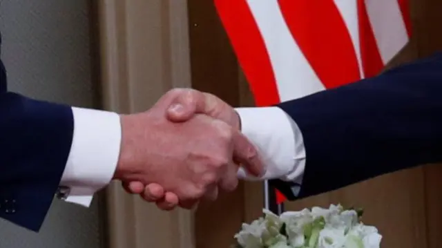 Close-up handshake of the two leaders