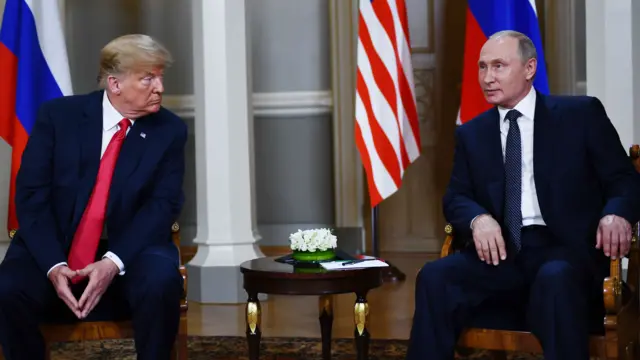 Russian President Vladimir Putin (R) and US President Donald Trump pose ahead a meeting in Helsinki,