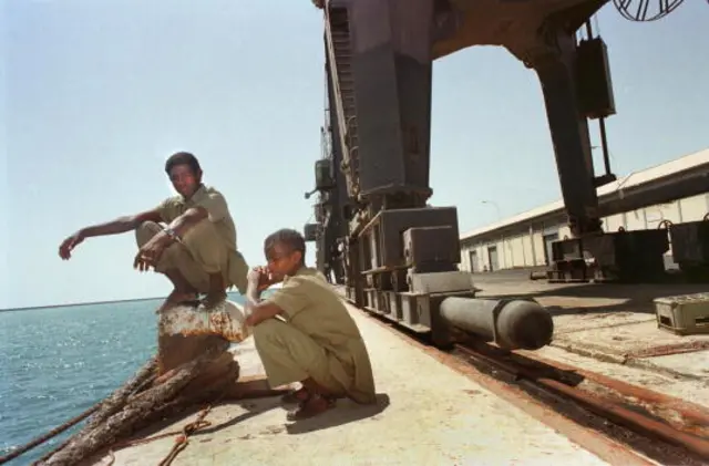 Two Eritrean employees of Assab Port in Assab, Eritrea sit with little work to do April 2, 2001