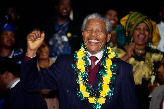 Winnie Mandela cheers her husband Nelson Mandela during his first ANC Conference in thirty years