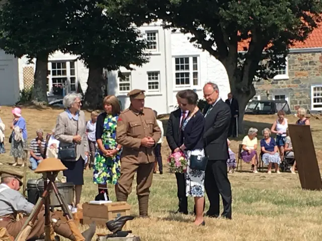 Princess Anne being shown a recreation of a military camp