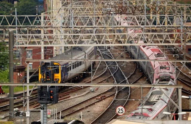 Northern Rail trains travelling on tracks outside Stockport railway station