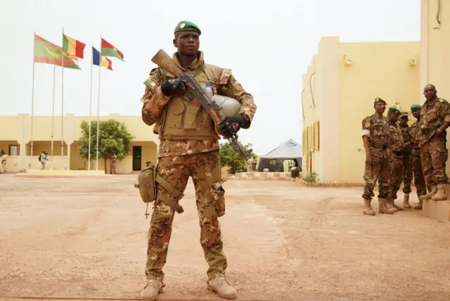 A Malian Army soldier with the G5 Sahel, an institutional framework for coordination of regional cooperation in development policies and security matters in West Africa, stands at the entrance of a G5 Sahel command post in Sevare on May 30, 2018.