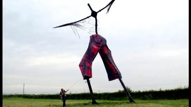 The skeleton of the giant sculpture Willow Man gets a final adjustment to his tartan Wrong Trousers for Wrong Trousers Day