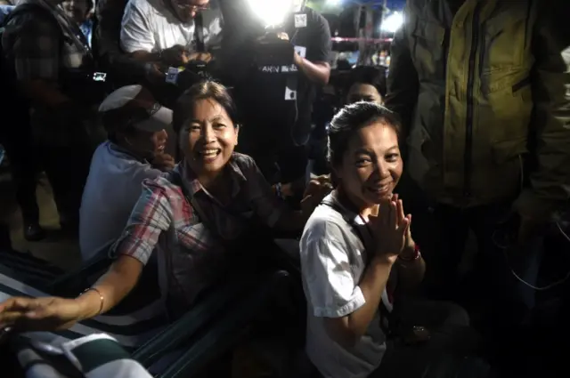 Family members celebrate while camping out near Than Luang cave following news all members of children"s football team and their coach were alive in the cave at Khun Nam Nang Non Forest Park in the Mae Sai district of Chiang Rai province late July 2, 2018.