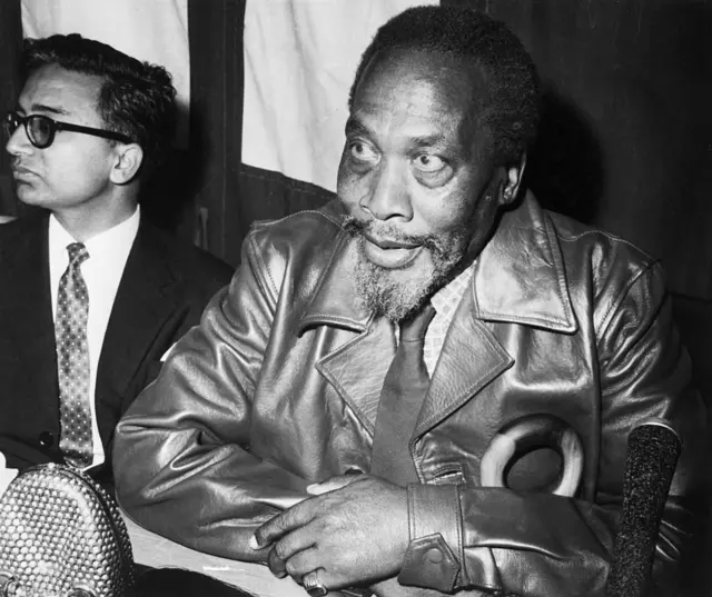 Jomo Kenyatta in a leather jacket