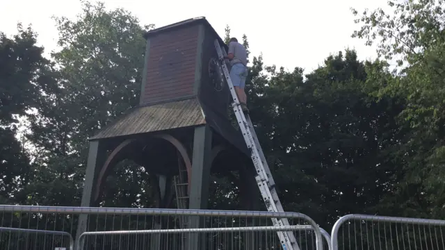 Man removing clocks