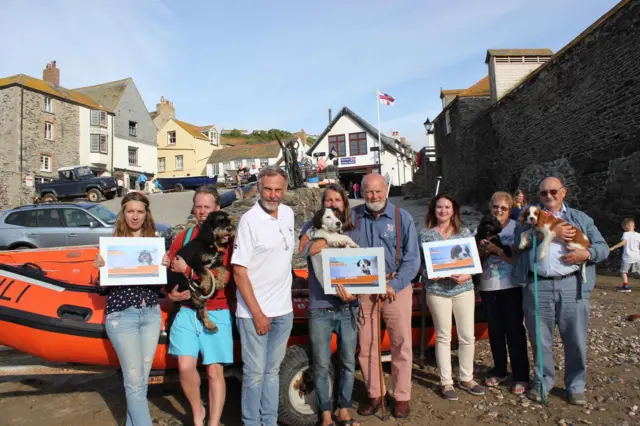 dogs and people with a boat