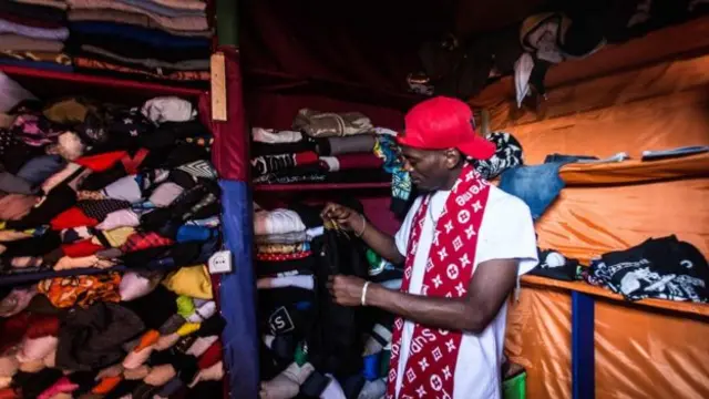 Man sorting second hand clothes