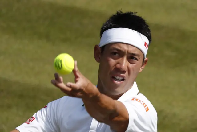 Kei Nishikori serves