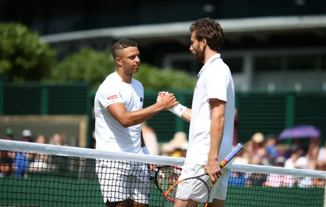 Ernests Gulbis shakes hands with Jay Clarke