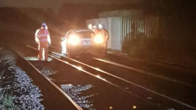 Car on railway tracks