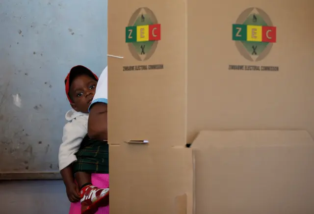 Baby on mother's back at polling station