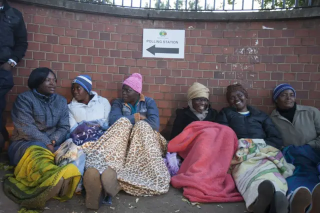 People wait in line before they cast their ballots during general election in Harare, Zimbabwe on July 30, 2018.