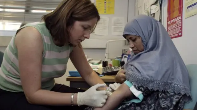 GP taking blood from a patient