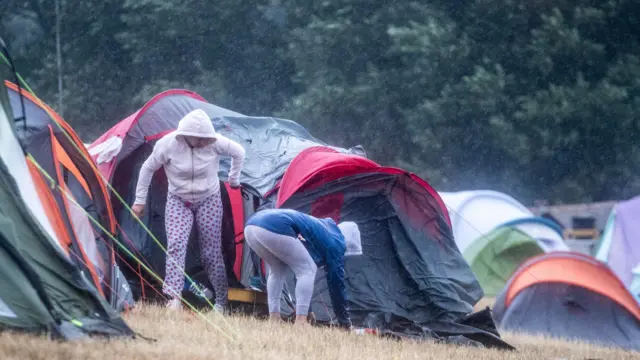 People pack up tents at Camp Bestival