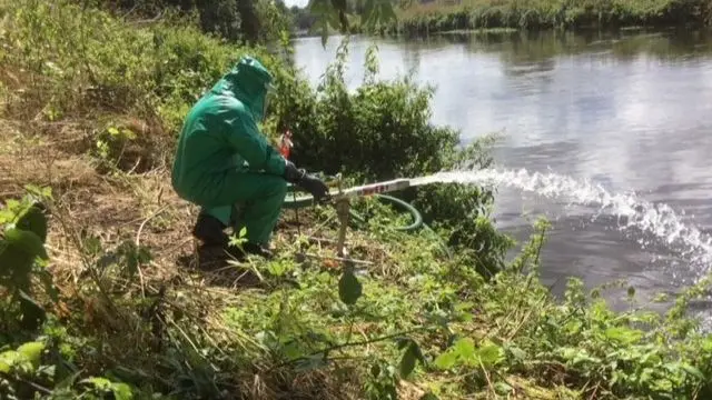 Man pumping oxygen via water into river