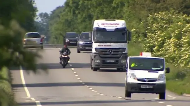 A motorbike overtaking lorries and cars on the A15.