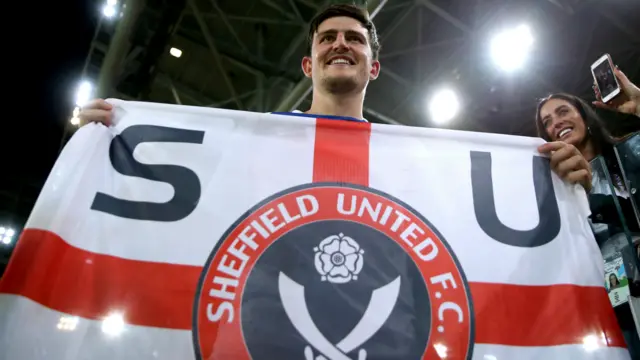 Harry Maguire with a Sheffield United flag