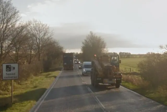 Traffic on the A15 following behind a tractor.