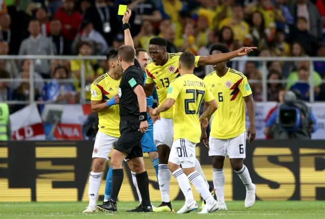 Colombia players surround referee