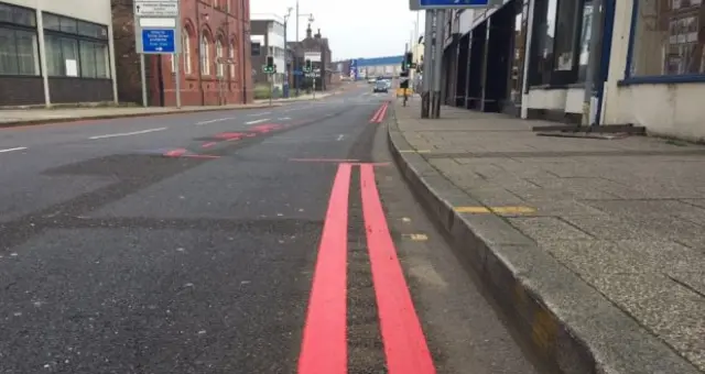 Red lines painted on a road