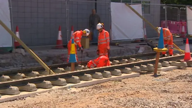 Workers laying tram tracks