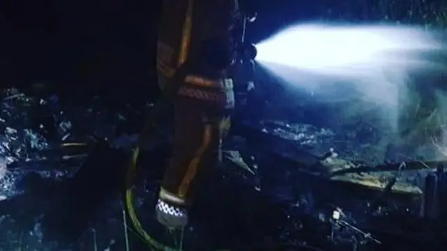 Firefighter spraying water