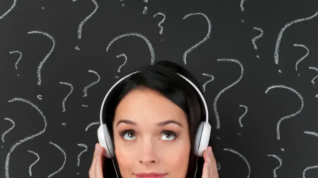 Stock image of a woman wearing headphones surrounded by question marks