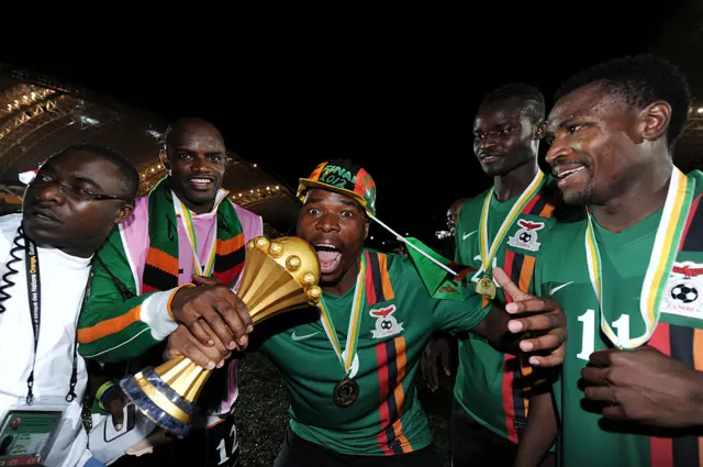 Collins Mbesuma of Zambia celebrates with the trophy the 2012 African Cup of Nations Final between Zambia and Ivory Coast