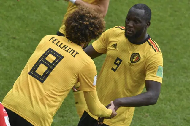 Belgium's forward Romelu Lukaku (R) speaks to his replacement Belgium's midfielder Marouane Fellaini